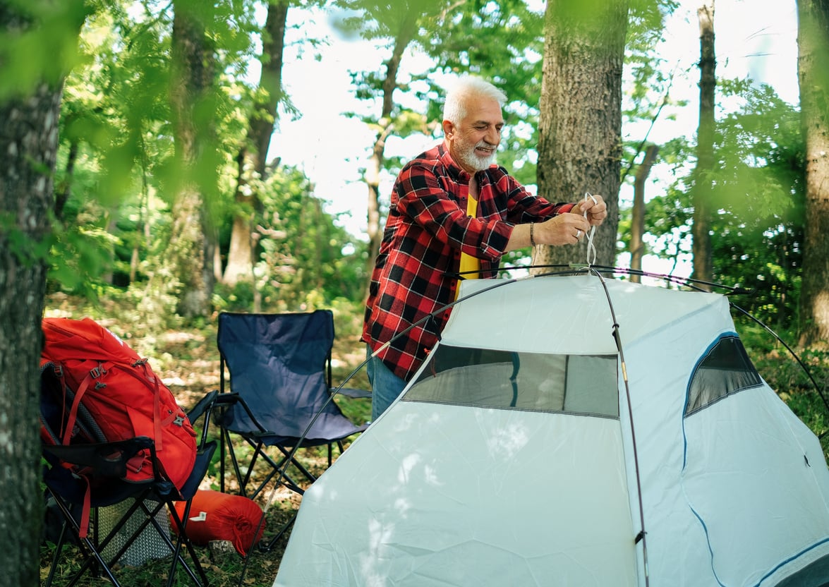 Old Man Pitching a Camping Tent