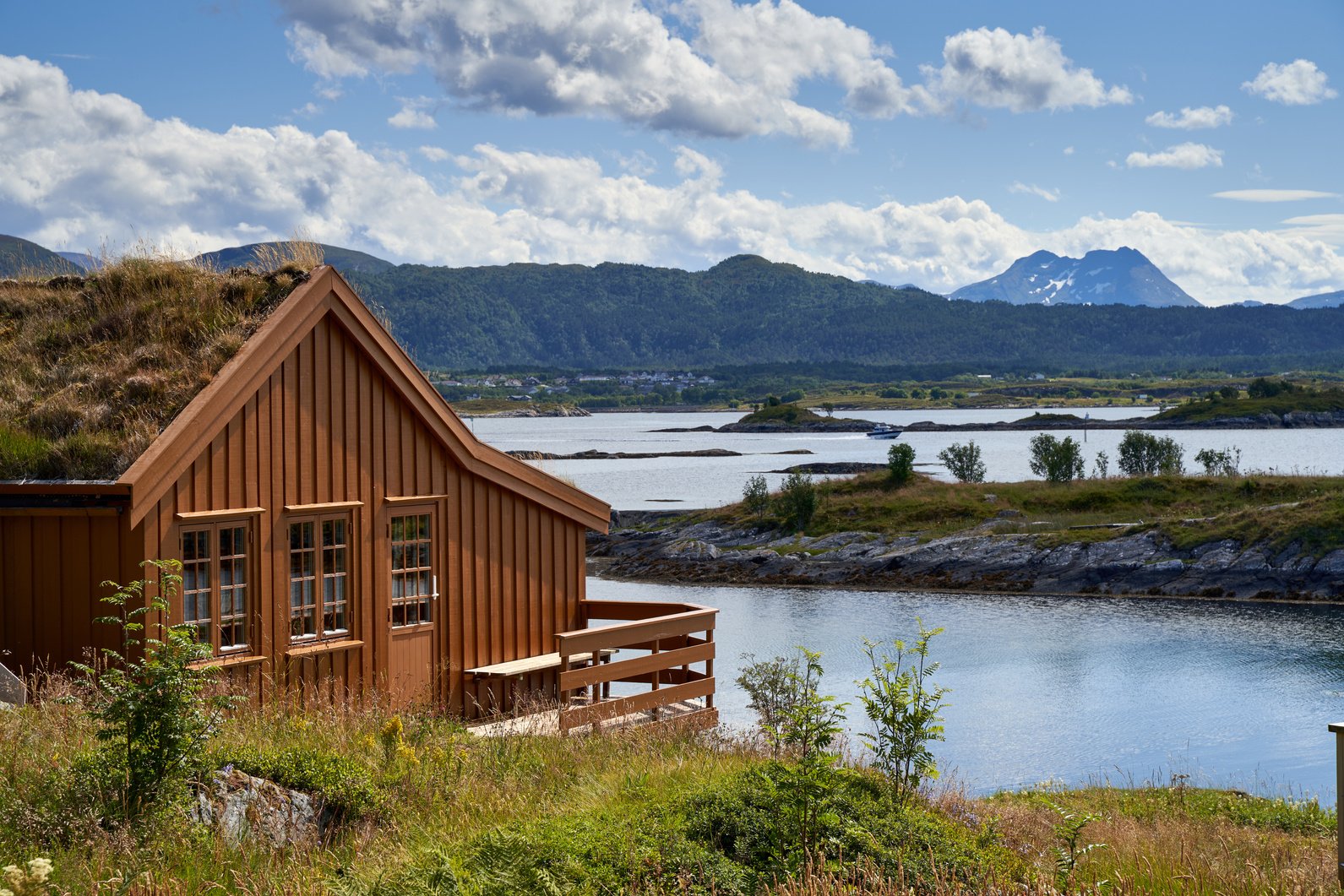 Wooden Chalet by Lake in Mountains